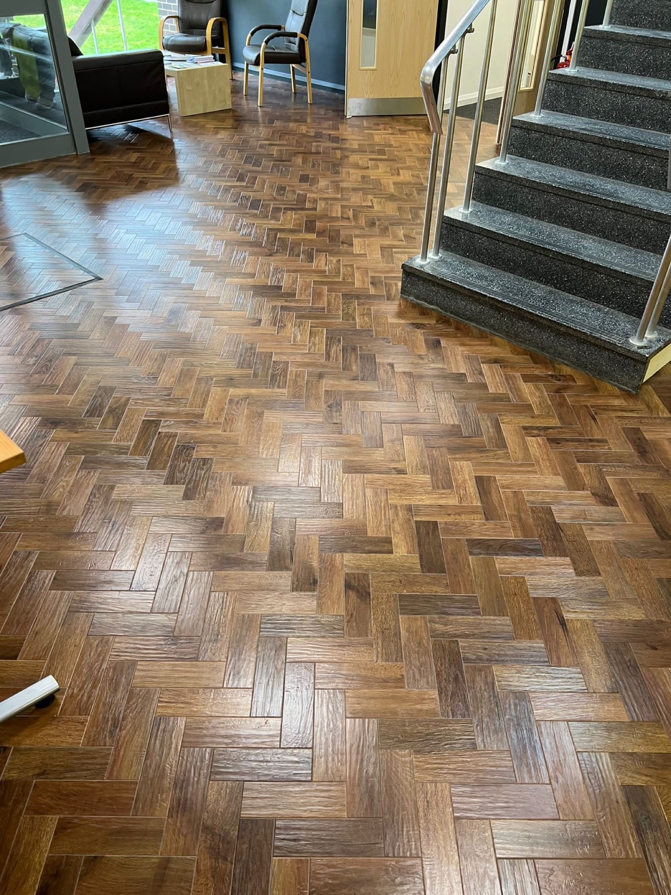 Parquet block flooring fitted in a commercial reception with granite staircase
