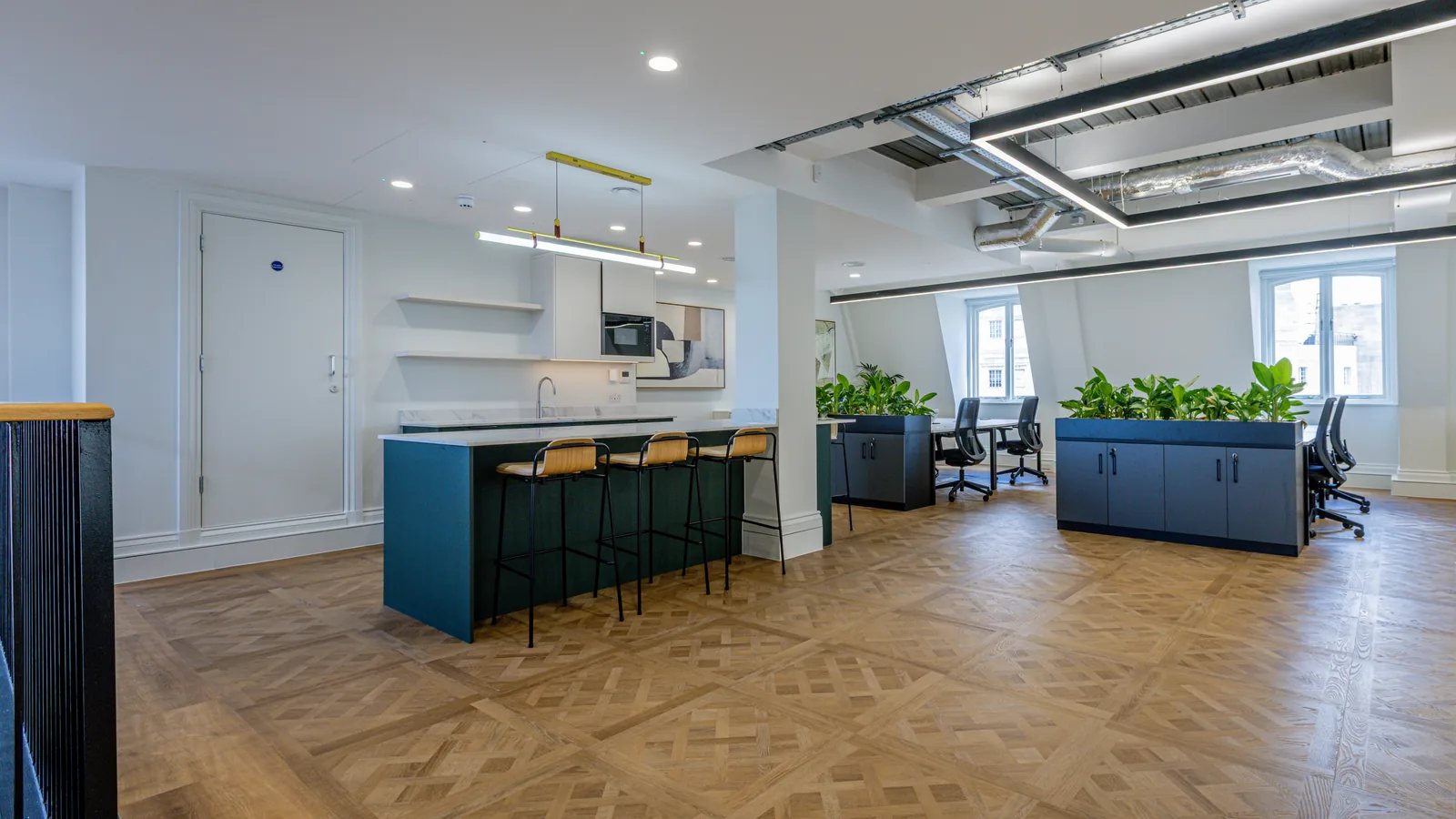 A finished herringbone floor running through a London office fitted by Guild Floors