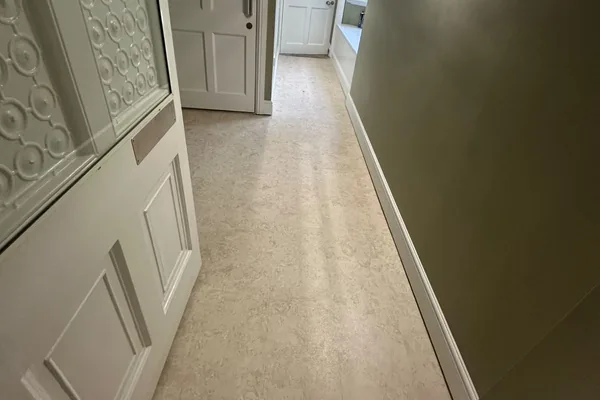 Cap and cove carried up the wall along a hallway