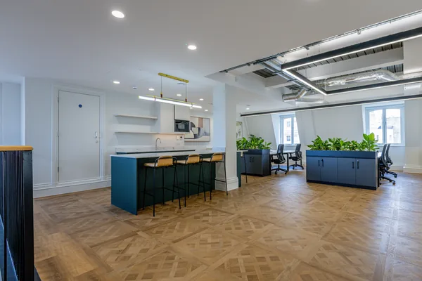 Herringbone wood-effect LVT running through an open-plan office at 1 Portland Place