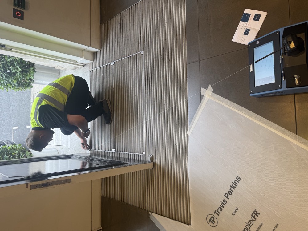 JG Floors fitter preparing and installing entrance matting on a commercial site