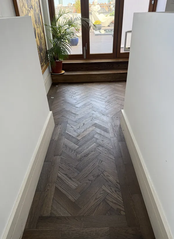 Dark herringbone parquet in the hallway of a period home
