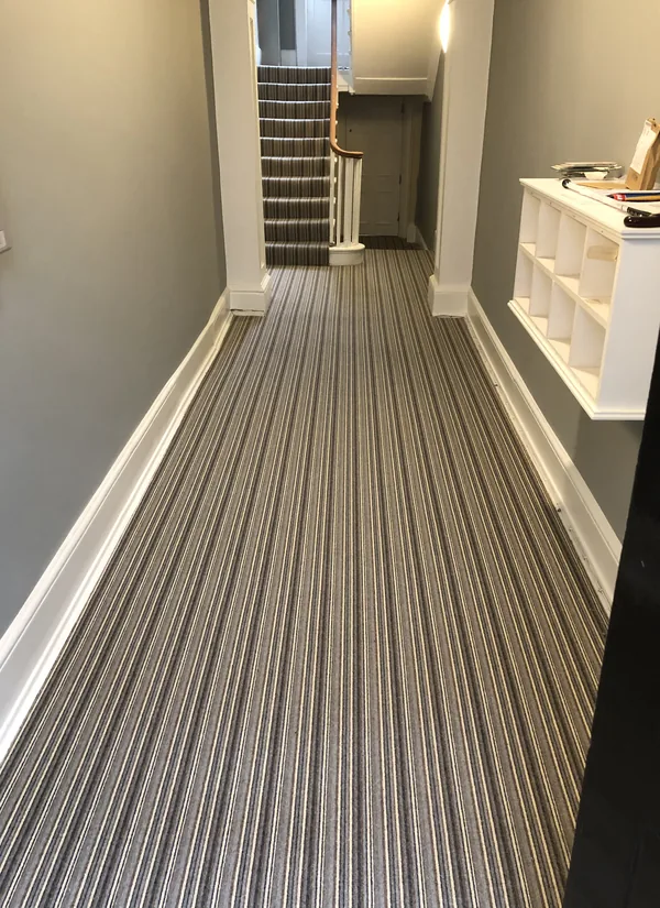 Striped runner carried down a hallway to the front door