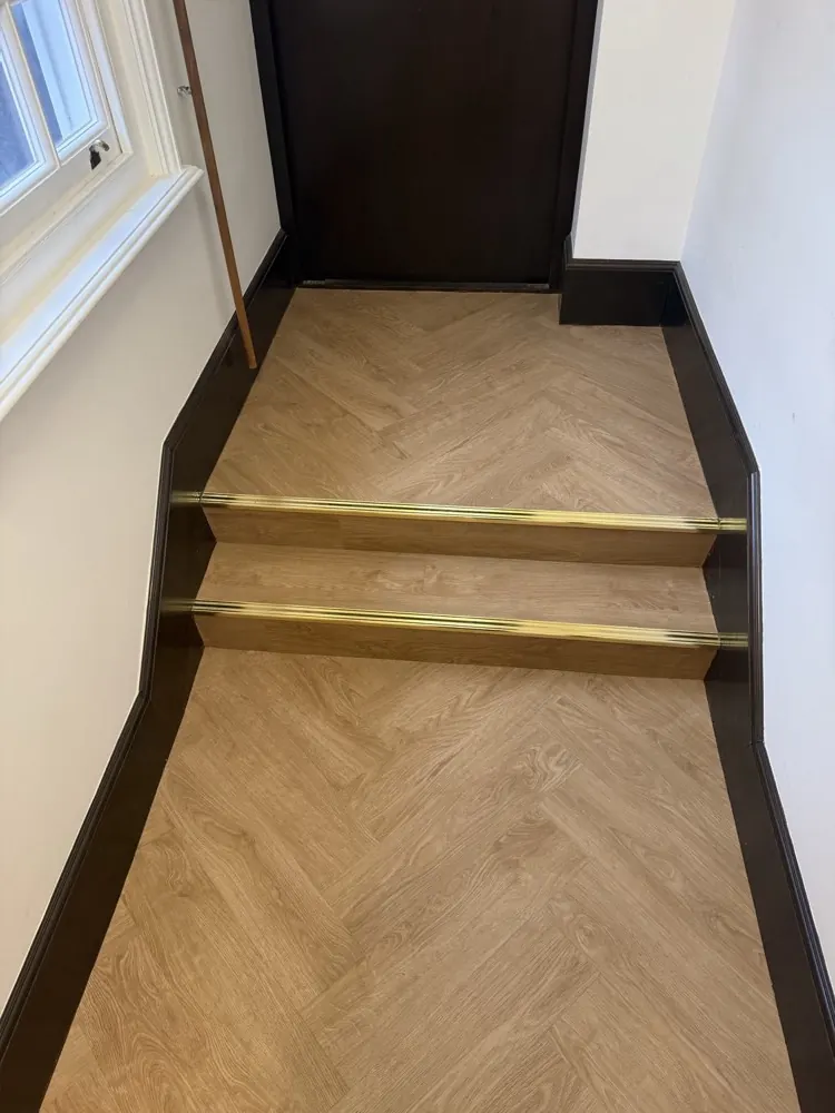 Herringbone stairs with brass nosings fitted by Guild Floors
